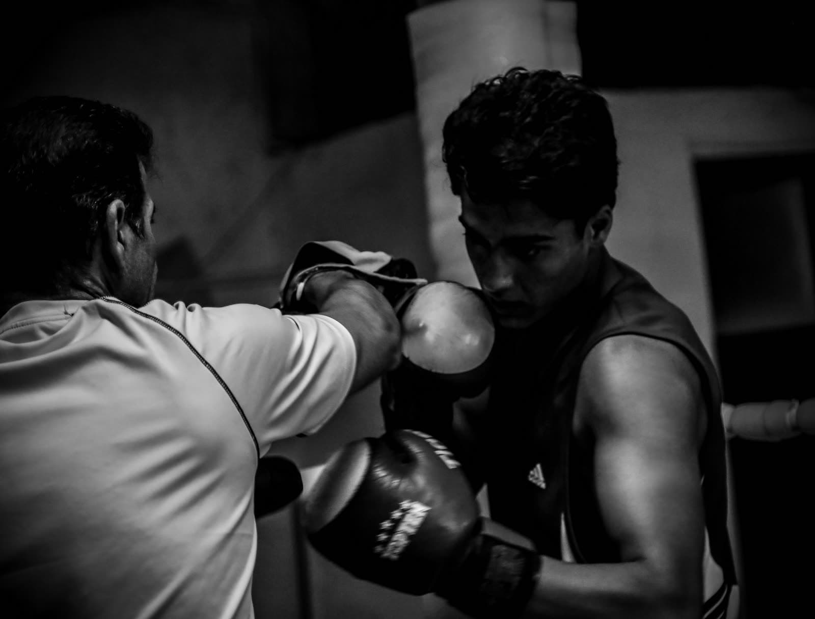 Two sparring partners training in a boxing gym